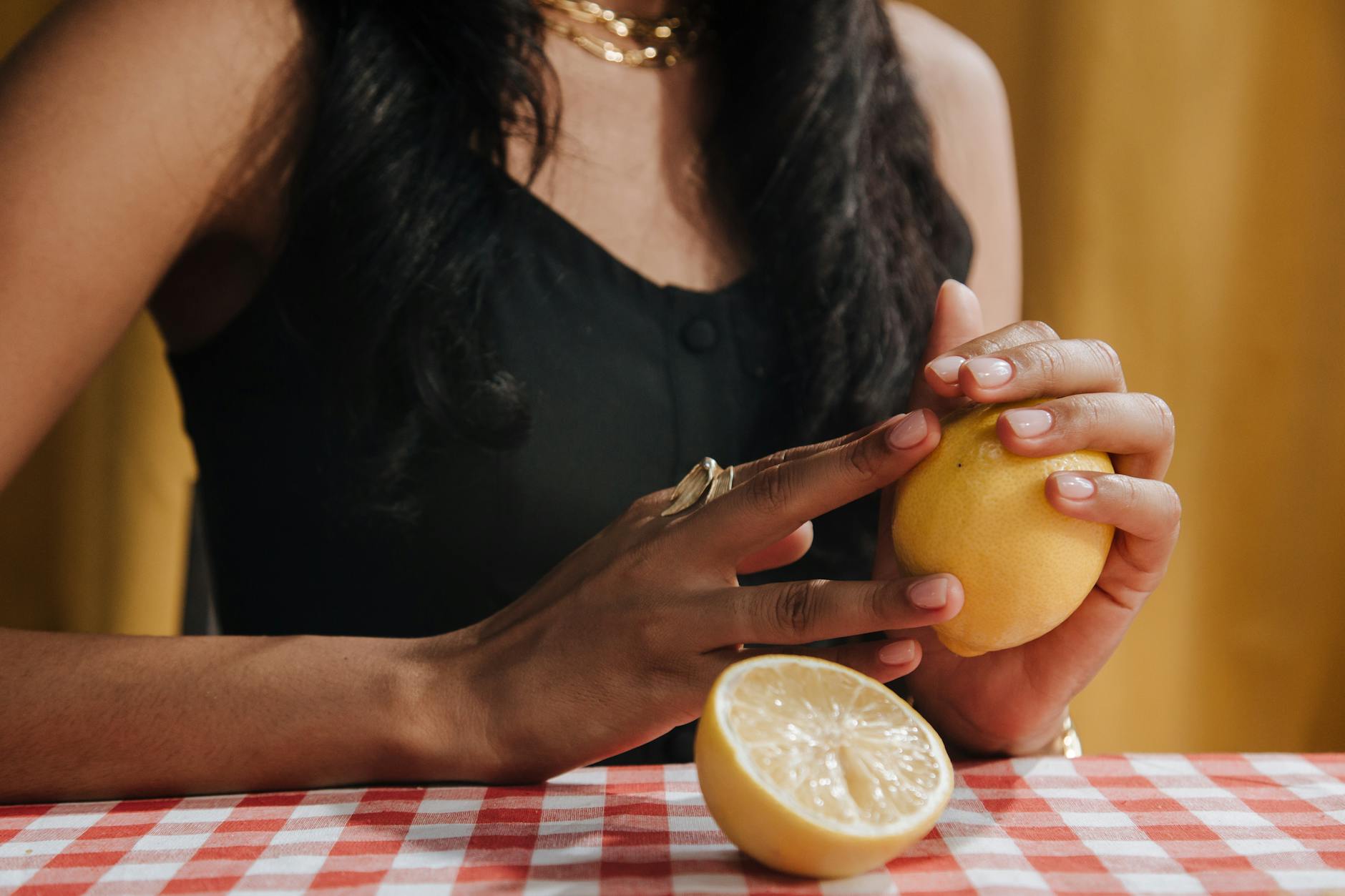Woman holding colorful vibrators with a calm, thoughtful expression