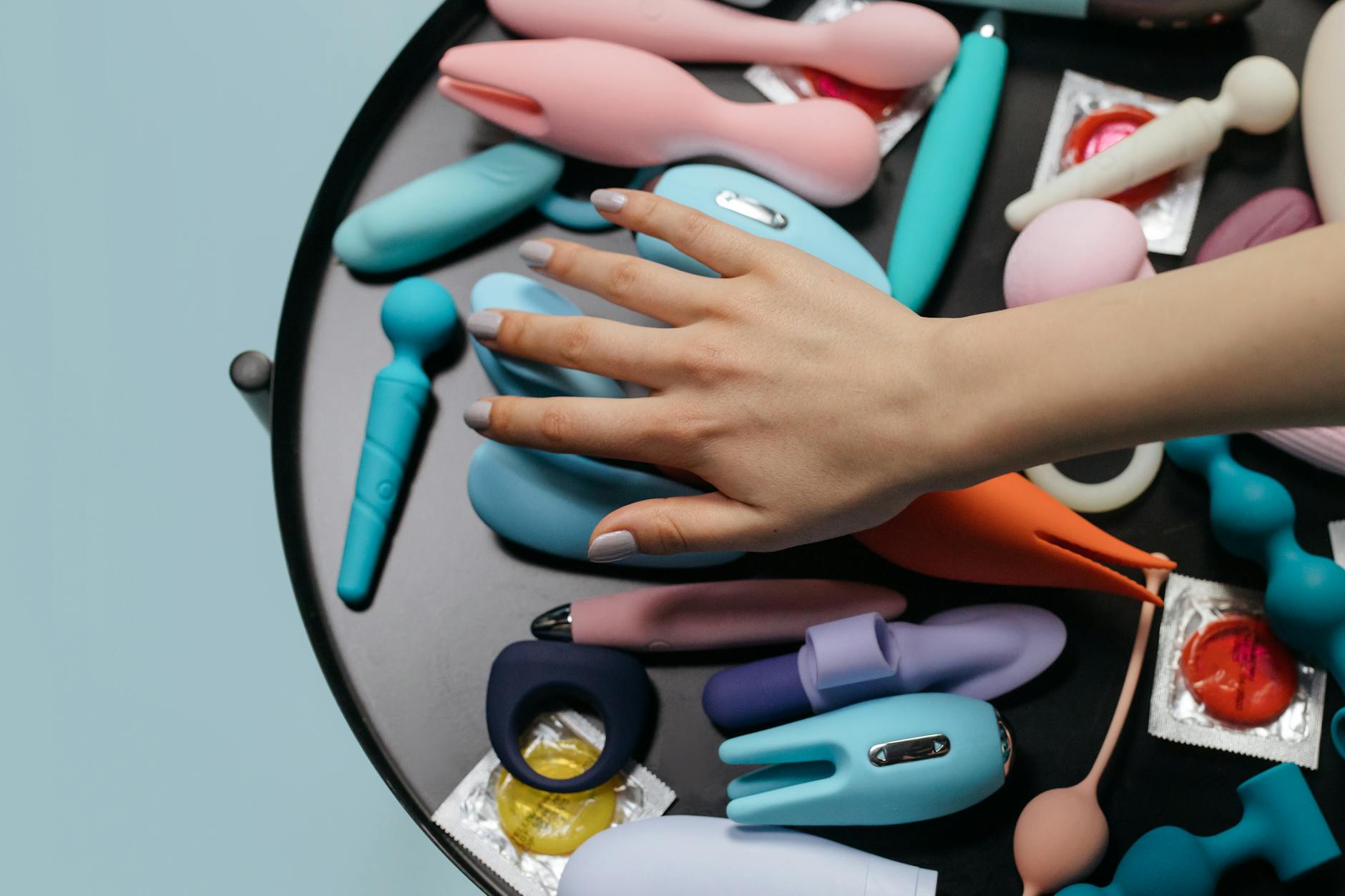 Close-up of a hand holding a vibrator, showcasing modern intimate wellness