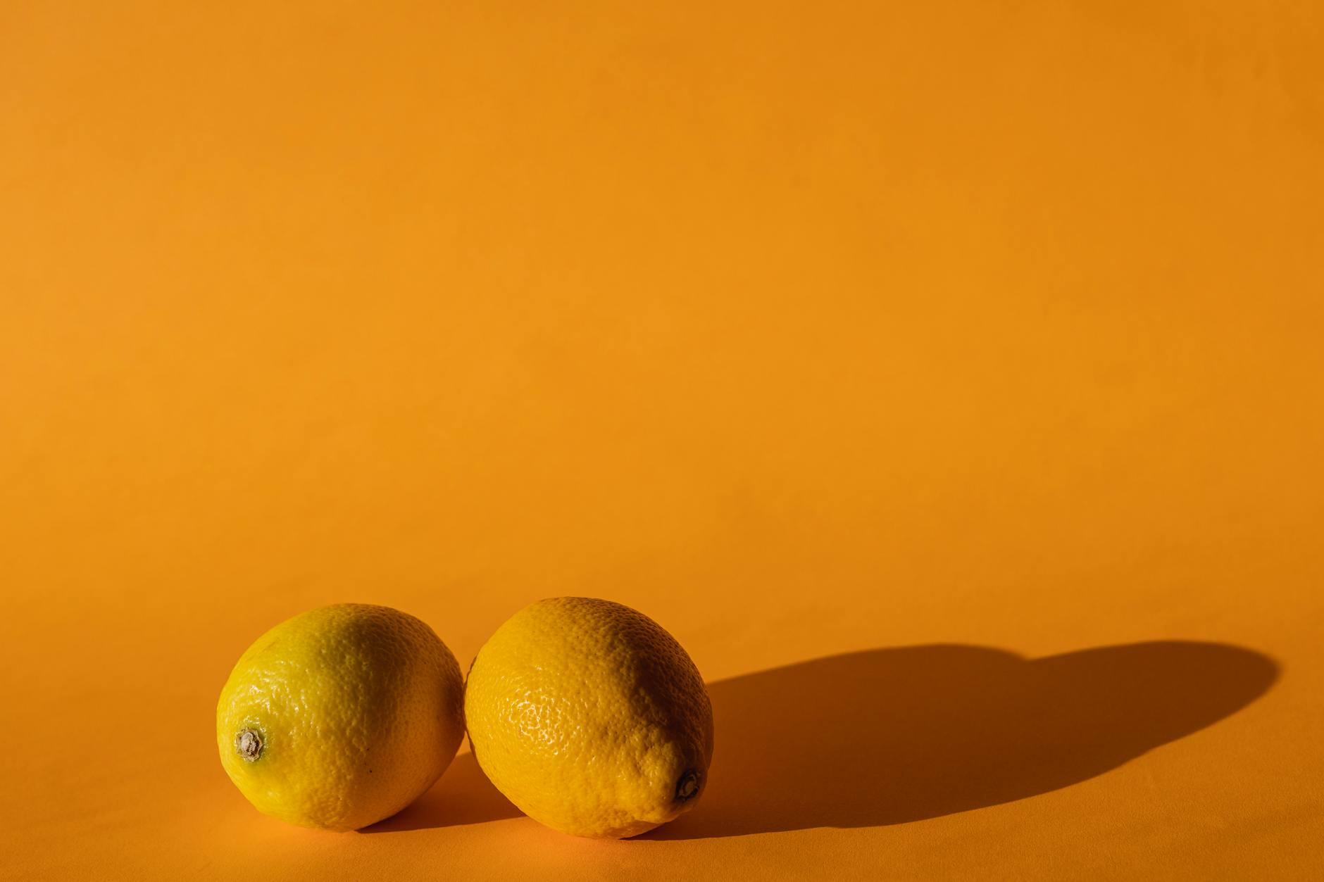 Fresh lemons arranged on a yellow background, representing renewal and rediscovery